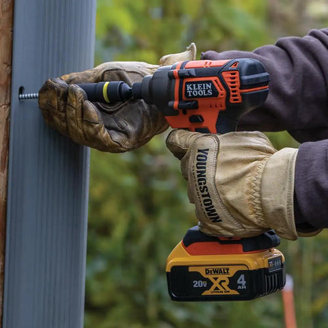 Worker uses 20V Battery Powered Impact Driver With One Quarter Inch Hex Quick Connect 210 Foot Pounds Max Torque Brushless Motor