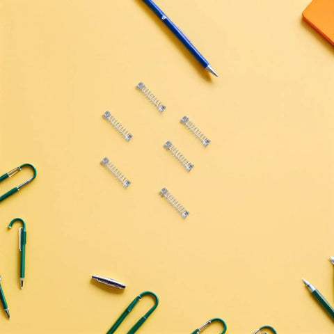 Top Tier 100 Pack Stainless Steel Compression Springs Kit For Ballpoint Pen Click Return Repair DIY Mechanical Tool Refurbishing Gear Silver Tone, six springs on yellow background