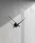 Upgrade Your Home With Top Tier XLWLLNJ Clock Movement Electronic Timekeeping Mechanism For DIY Restoration Projects Including Shaft Mounting Hardware Suitable For Living Room Classroom Studio Color Options Up To 2 With 18MM Shafts black clock with long hands mounted on a textured gray wall.