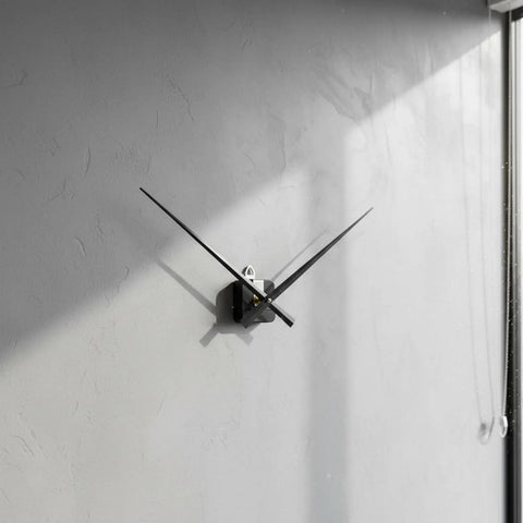 Upgrade Your Home With Top Tier XLWLLNJ Clock Movement Electronic Timekeeping Mechanism For DIY Restoration Projects Including Shaft Mounting Hardware Suitable For Living Room Classroom Studio Color Options Up To 2 With 18MM Shafts black clock with long hands mounted on a textured gray wall.