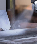 Professional Self Etching Weld Through Gray Primer For Metal Surfaces With Zinc Enhanced Coating spray being applied to metal.
