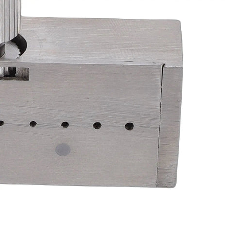 Close-up of stainless steel watch gearwheel reaming tool for minute wheel tightening and precision gear adjustments