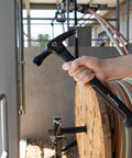 Person holding 18 Oz Electrician Hammer With Extended Neck For Tight Spaces, Romex Staple Remover, Tether Hole For Safety