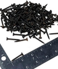 Pro Grade Drywall Screws For Light Gauge Steel Studs Size Six By One And A Quarter Inch scattered over a ruler.