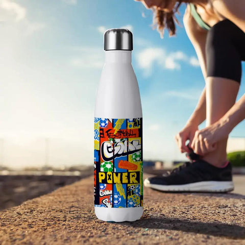 17 Oz White Stainless Steel Sublimation Water Bottle with colorful design, standing on a ledge with a person tying a shoe in the background