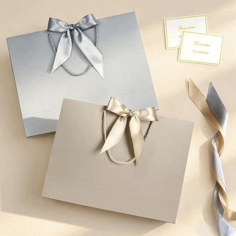 Two medium 13 inch champagne gold gift bags with handles and bows, includes tissue paper and card, perfect for all occasions.
