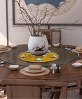 Flawless Finish Tempered Glass Lazy Susan And Smooth Gliding Rotating Serving Tray on a wooden dining table with dishes and decor.