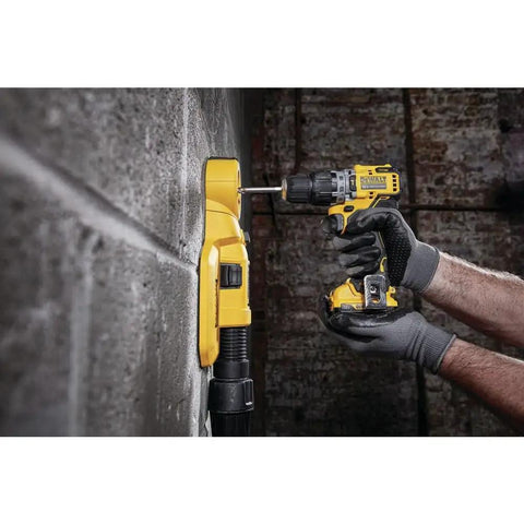Person using 12V Max XR Hammer Drill Bare Tool on a concrete wall, showcasing ultracompact design and LED light feature.