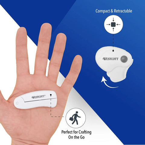 Titanium Bonded Mini 3 Piece Travel Cutters Set With Folding Scissors on hand showing compact size and retractable design.