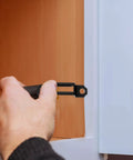 Person installing a 100 Piece Invisible Connector Screw for hidden furniture fasteners in cabinet assembly.