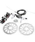 Heavy Duty Mountain Bike Hydraulic Disc Brake Set With Slick Pad Compatibility And Killer Heat Management For Bulletproof Stopping Power On Gnarly Race And Trail Rip Runs with two rotors and black and white calipers.