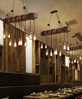 10 Light Rustic Wood Chandelier Pendant Light With Adjustable Suspension Chain in dining setting, farmhouse style.