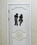 Removable Man And Woman Washroom Sign For Restroom Door Sticker DIY Wall Decor, black PVC, on white door.