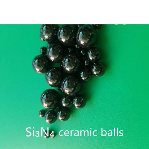 Twenty Piece Lot Of 1.588Mm Silicon Nitride Ceramic Balls G5 Grade on green background, showcasing black precision balls.
