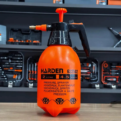 0.53 Gallon Handheld Pump Sprayer With Adjustable Copper Nozzle for plants and lawn care on a wooden table in a workshop