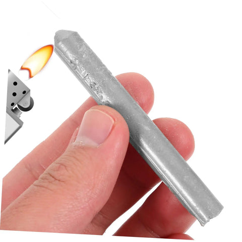 Close-up of hand holding Low Temp Aluminum Welding Rods Set 6 Pack Multipurpose Welding Sticks next to small flame for heating.