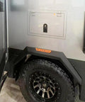 Sealed compression latch, flush-mount, black, on gray off-road vehicle side panel