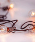 Close-up of G40 Replacement Bulbs 120V 5W Incandescent Globe Bulbs, 1.5 Inch Clear Globe, outdoor string lights glowing warmly