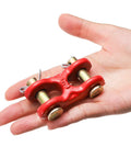 Hand holding a red G70 Zinc Plated Twin Clevis Link from Six Pack 5/16 Inch G70 Zinc Plated Heavy Duty Trailer Tie Down.