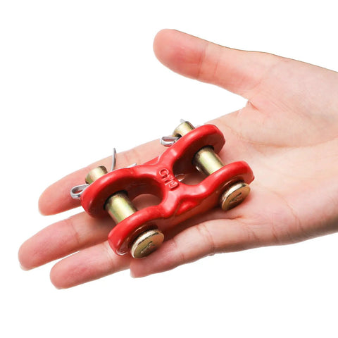 Hand holding a red G70 Zinc Plated Twin Clevis Link from Six Pack 5/16 Inch G70 Zinc Plated Heavy Duty Trailer Tie Down.