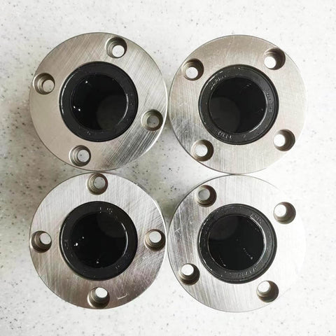 Top view of four Flanged Linear Bearing Bushing LMF25UU Chrome Steel SAE 52100 with Rubber Sealed Closure on a white surface.