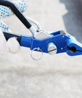Kick Your Packaging Game Up With This Heavy Duty Steel Strapping Kit Featuring Smooth Ratchet Tensioner And Easy Cut Tool For Pallet Banding Plus Three Quarter Inch Coil And One Hundred Clips. Close-up of blue manual ratchet tool in use.