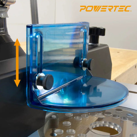 Router Table Dust Port And Bit Guard Kit For Safe Routing with blue tint guard and knobs on a wooden table edge, close-up view.