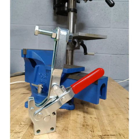 Badass Heavy Duty Vertical Toggle Clamps 10 Pack secured on a blue workbench vise, showcasing robust clamp design for woodworking.
