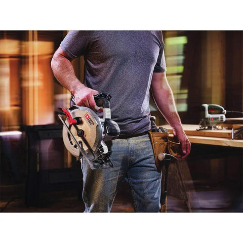Person holding Heavy Duty 7-1/4 Inch Circular Saw With 15 Amp Motor Delivers 5500 RPM Magnesium Shoe And Metal Guards For Durability
