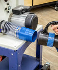 Heavy Duty 4 Inch Dust Collector Hose Splice Fitting With Quick Change Handle And Built-In Swivel To Stop Hose Twisting connected to a machine.
