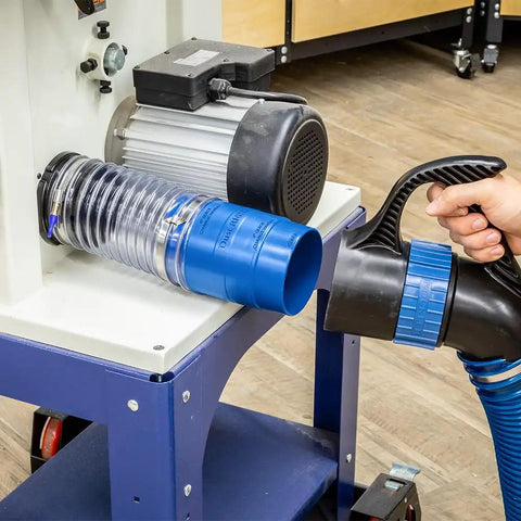 Heavy Duty 4 Inch Dust Collector Hose Splice Fitting With Quick Change Handle And Built-In Swivel To Stop Hose Twisting connected to a machine.