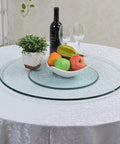 Tempered Glass Lazy Susan Turntable Rotating Tray on dining table with fruit and wine, large diameter, smooth 360 spin.