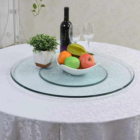 Tempered Glass Lazy Susan Turntable Rotating Tray on dining table with fruit and wine, large diameter, smooth 360 spin.