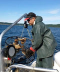 Man using Beefy Heavy Duty Crab Pot Puller With 2.3 HP 90 To 1 Powerdrive Gear System on boat.