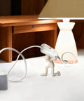 White Thumb-Control Inline Power Button Switch For Lamps And Small Devices Dual Pole AC Handles 12V To 250V Up To 2A Quick Wire Connect Safe Housing Perfect DIY Light Fix For Home Or Office in use on a desk with lamp.