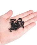 Level Up Your Furniture Game With These Rock Solid Black Carbon Steel Upholstery Tacks 50 Pack Smooth Grip Thumb Pin Nails in a hand.