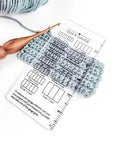 Super Crisp Acrylic Gauge Ruler For Knitting And Crochet No Sweat Stitch Measurement Guide With Transparent Grid over fabric swatches.