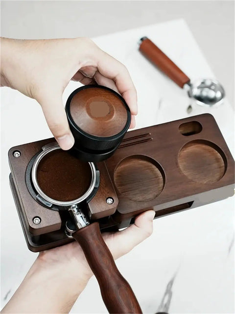 Person using Smooth Operator Wood Espresso Tamper Station with 51 and 58 mm coffee basket and wooden tamper in hand.