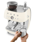 Top Shelf Semi Automatic Espresso Machine With Built In Conical Burr Grinder Dual Thermoblock Heating Precision Controls And Authentic 1950s Retro Vibe In Smooth Cream Finish with milk frother and gauge.