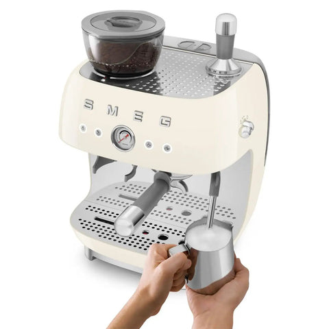 Top Shelf Semi Automatic Espresso Machine With Built In Conical Burr Grinder Dual Thermoblock Heating Precision Controls And Authentic 1950s Retro Vibe In Smooth Cream Finish with milk frother and gauge.