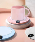 Ditch Cold Coffee And Keep Your Morning Brew Piping Hot With This Electric Mug Warmer featuring three heat settings on a pink base.