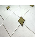 Close-up of Thassos white marble and gold glass diamond mosaic tile sheet, 3x3.5 in, polished waterjet-cut for walls/floors.