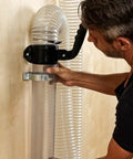 Man connecting 4 inch clear dust pipe to wall mount using quick connect coupler from Heavy Duty Dust Collection Floor Sweep And 4 Inch Clear Dust Pipe Accessory Kit.