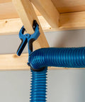 4 Inch Clamping Hose Holders Pack Of 2 With Spring Clamps And Non Slip Rubber Grip For Dust Collection Nylon And Thermoplastic Build 3 Inch Jaw Opening No Fuss Mounting For Woodworking Shops securing blue hose to wooden beam