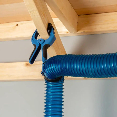 4 Inch Clamping Hose Holders Pack Of 2 With Spring Clamps And Non Slip Rubber Grip For Dust Collection Nylon And Thermoplastic Build 3 Inch Jaw Opening No Fuss Mounting For Woodworking Shops securing blue hose to wooden beam