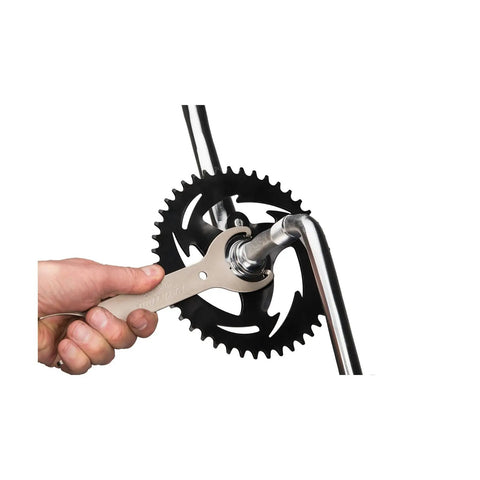 Using Beefy Bottom Bracket Wrench For Bicycle Maintenance And Repair on bike crank with grippy steel design.