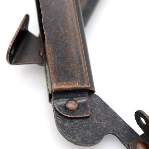 Close-up of self balancing lid support hinges set for left and right in dark bronze finish with screws, heavy duty spring hinge design.