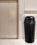 Top Shelf Commercial Trash Can And Outdoor Garbage Bin With Snug Lid Super Tough Stainless Steel Waste Container Made To Take A Beating For High Traffic Shops Or Offices Matte Black Trim near elevator.