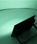 Back view of SUNGOOYUE LED Flood Light RGBW Color Changing casting green light on a white surface.