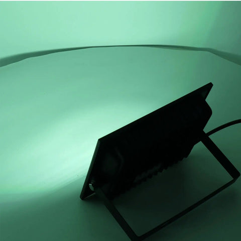 Back view of SUNGOOYUE LED Flood Light RGBW Color Changing casting green light on a white surface.